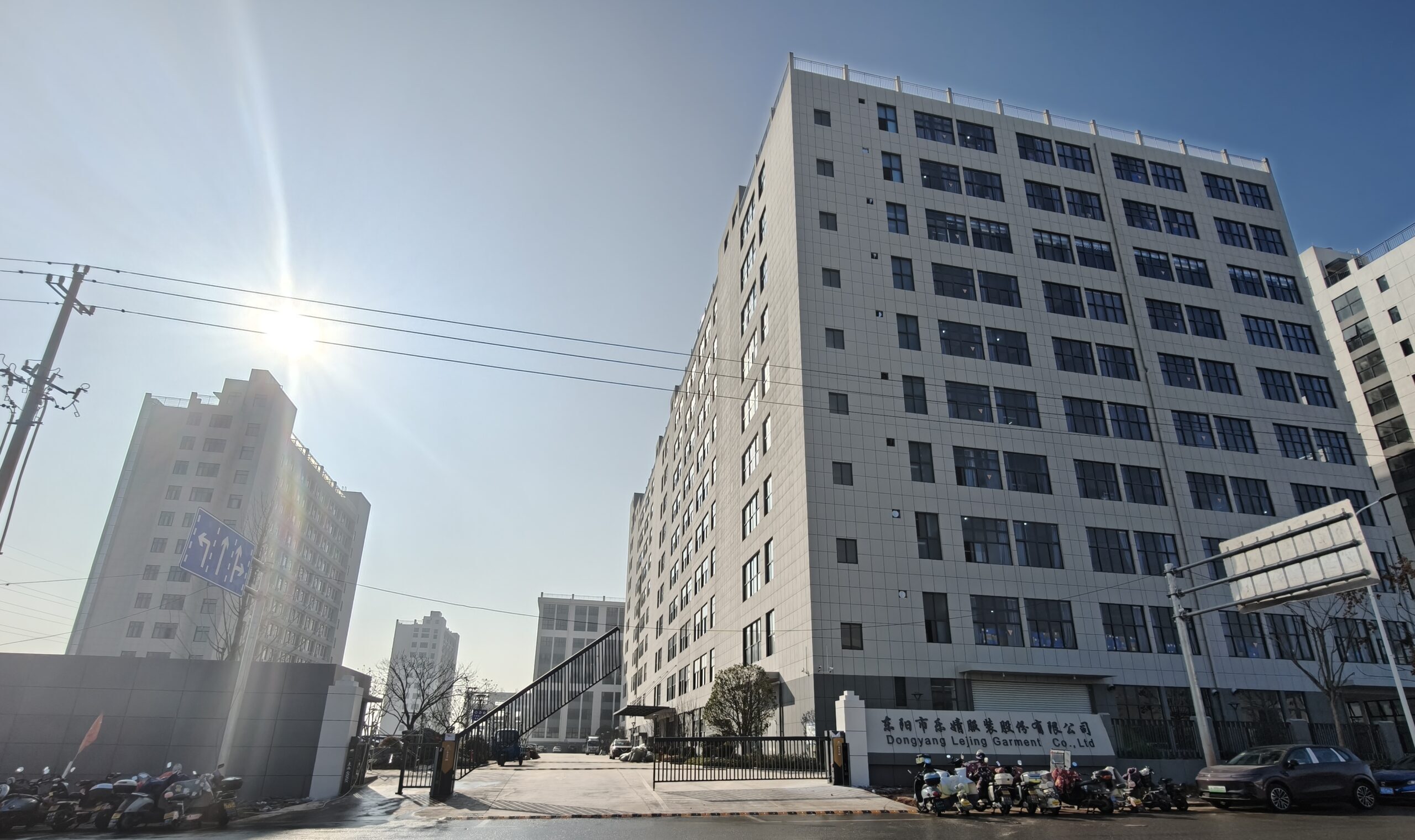 LJ Garment's New Production Base An architectural rendering of the new, modern LJ Garment factory and dormitory buildings