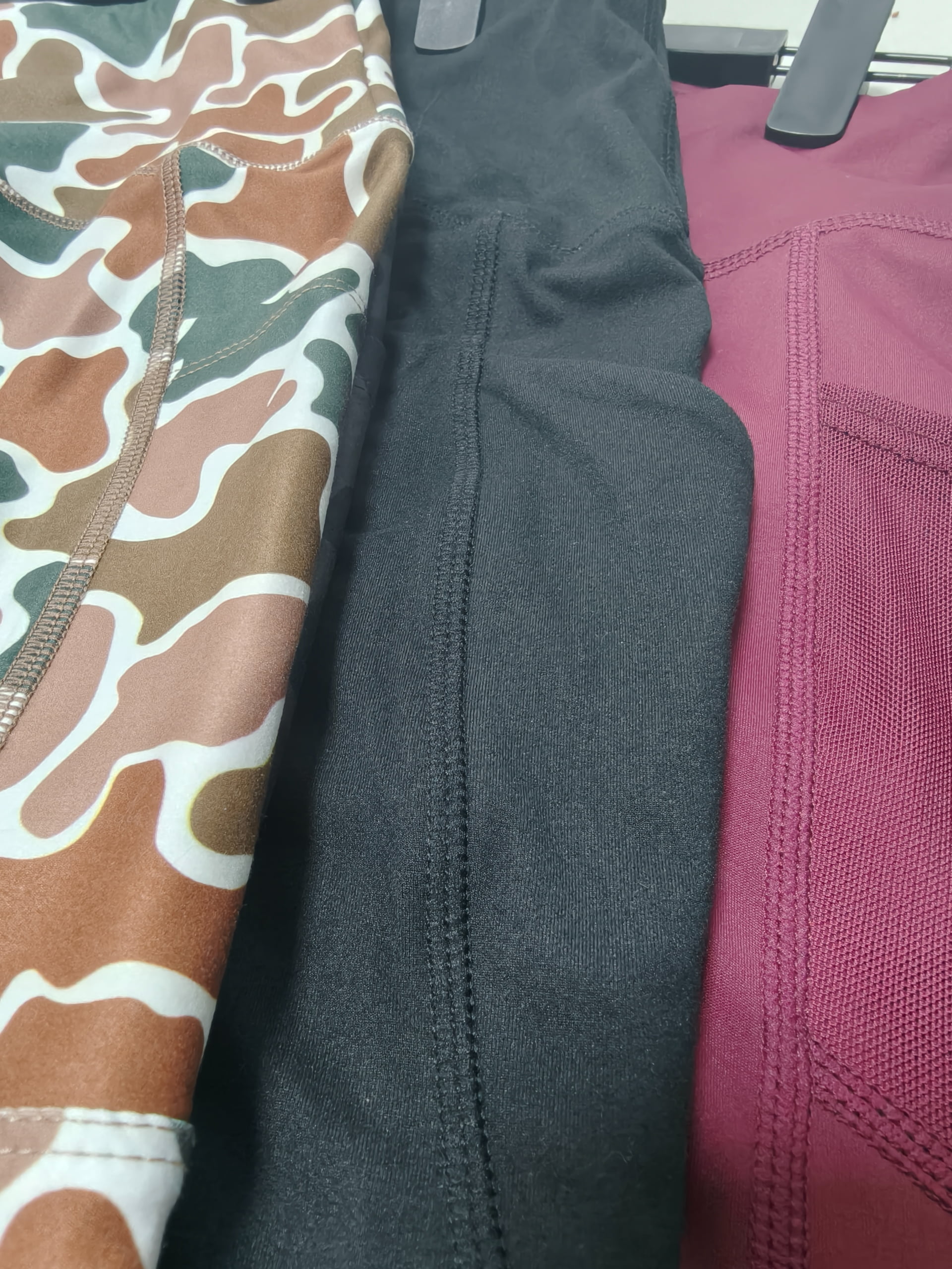 High-resolution macro close-up of flatlock stitching on premium yoga legging fabric
