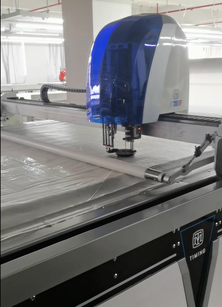Industrial automatic laser fabric cutting table in operation