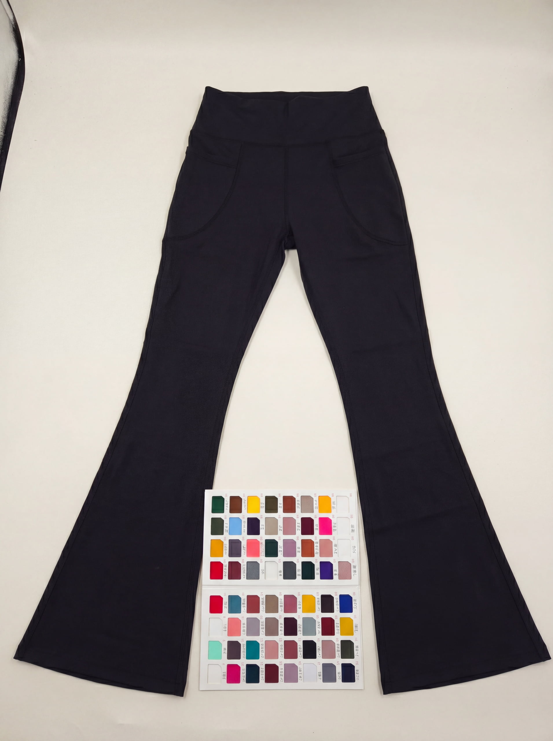 In-house stock fabric color swatches next to a finished flare yoga pant sample